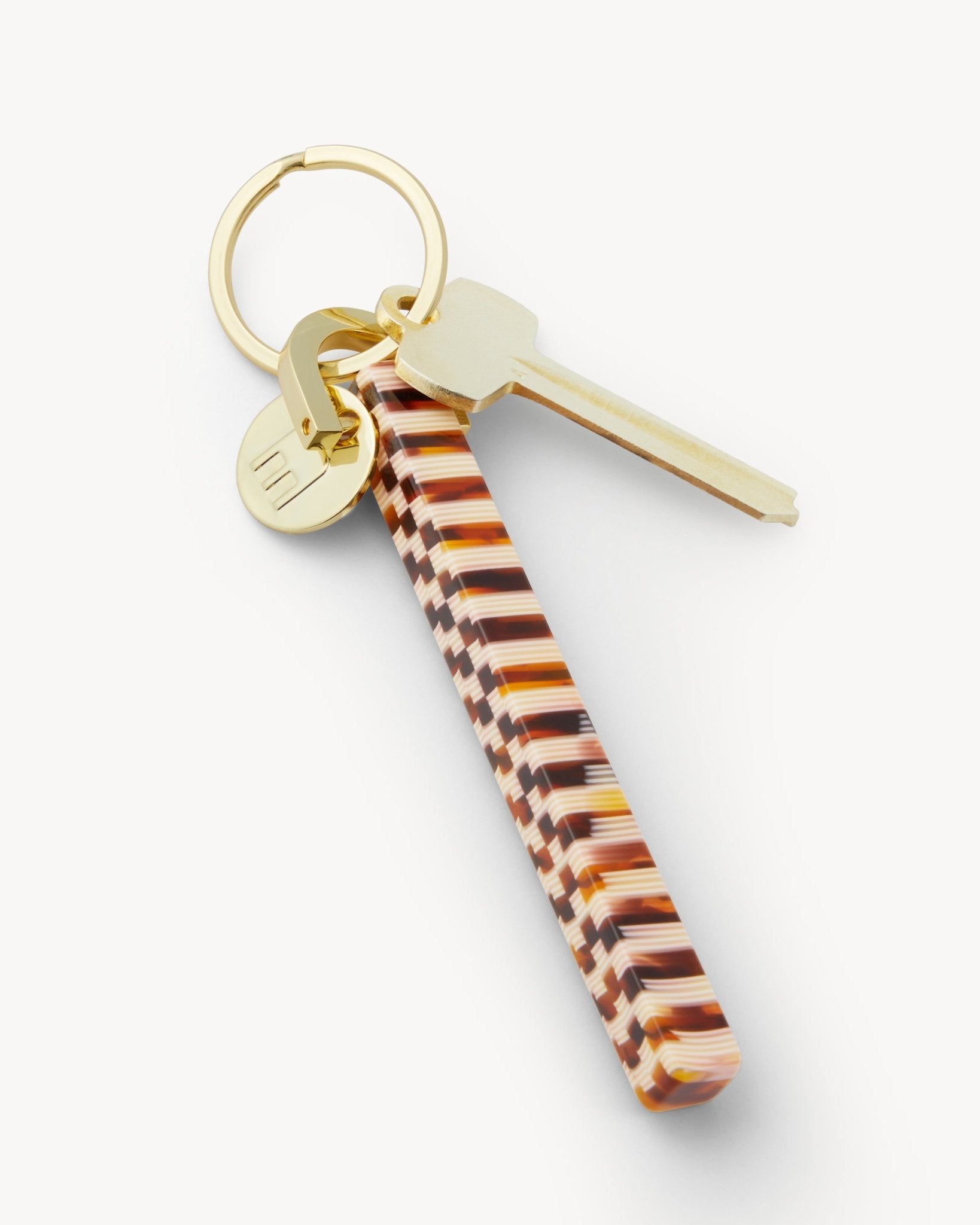 Tory Burch shops tortoise logo key chain.